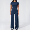 A woman wearing a navy blue women's premium fitness tracksuit top and matching pants.