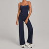 A woman wearing a navy blue high-waist yoga and fitness tracksuit set with matching top and pants.