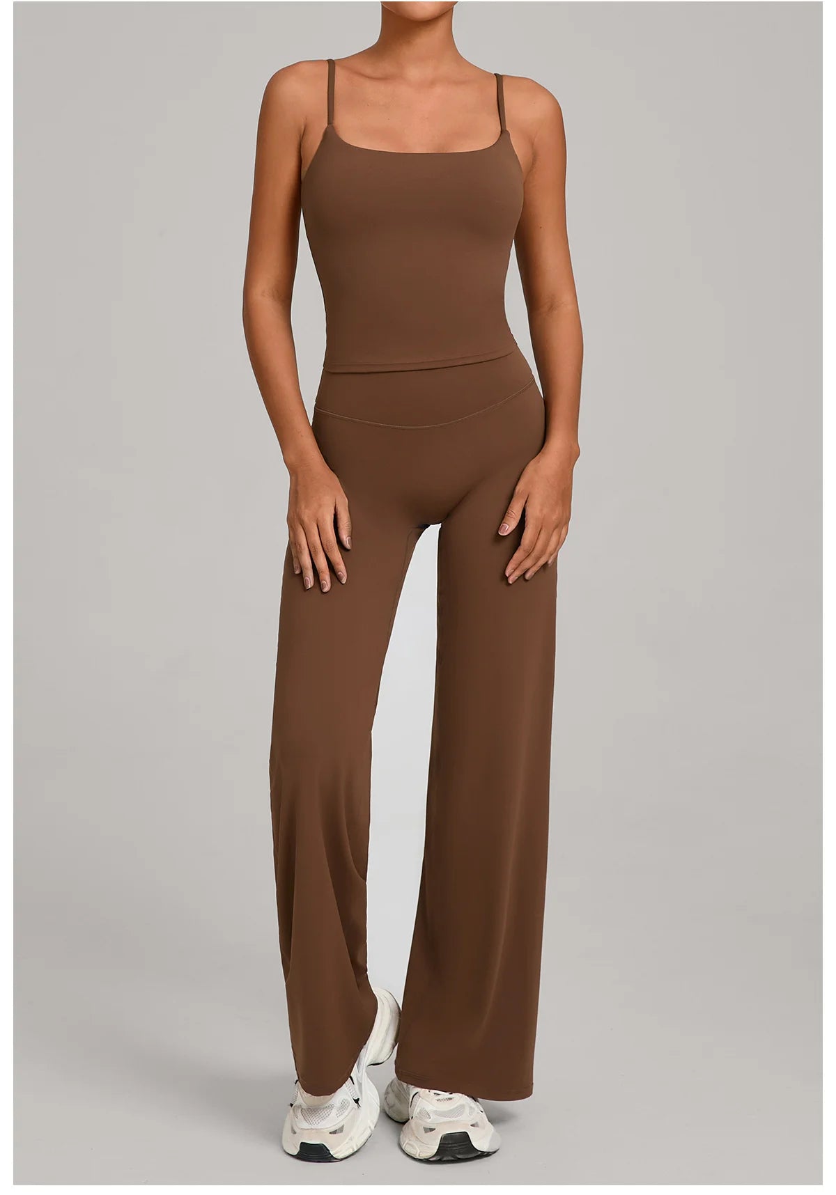 A woman wearing a mocha brown high-waist yoga and fitness tracksuit set.