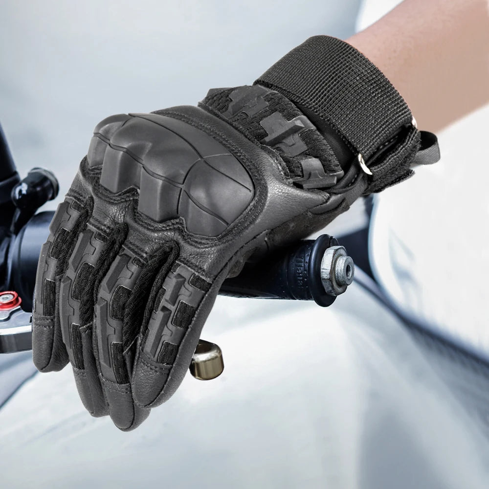 A close-up of black tactical outdoor gloves worn on a hand, showing the textured grip and wrist cuff.