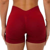 A model wearing red seamless yoga shorts for fitness and workout.