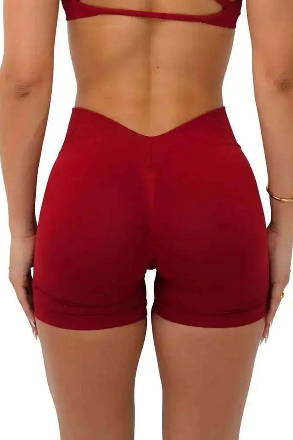 A model wearing red seamless yoga shorts for fitness and workout.