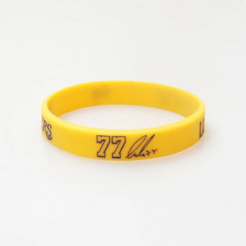 Yellow silicone wristband with black text reading 77 Larry