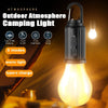 A black outdoor atmosphere camping light with a warm yellow glow, shown next to a Type-C charging cable.