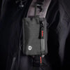 A black slim RFID blocking wallet is clipped onto a dark jacket strap.