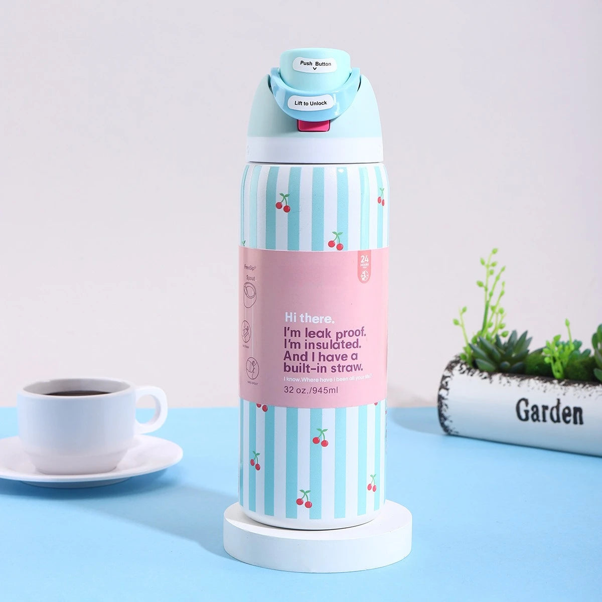 A pink and blue striped stainless steel vacuum insulated water bottle with a push button lid and straw, sitting on a white ba