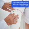 Hands are carefully using a bandage clip on a white elastic compression bandage for sports and first aid.