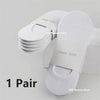 A pair of white invisible silicone no-show boat socks stacked on a white box.