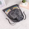 A dark gray reusable non-woven shoe storage bag with white outline drawings of sneakers and shoes.