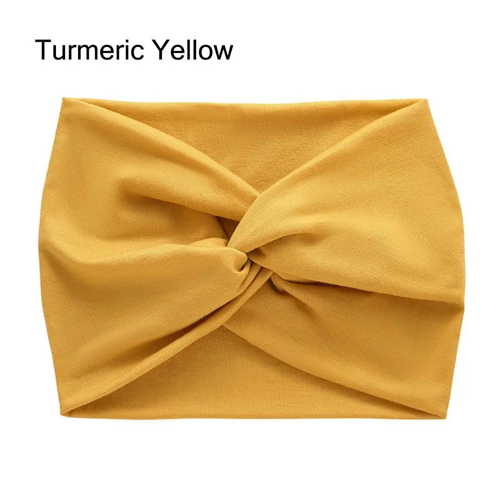 Bandeau en tissu jaune moutarde avec un nœud torsadé.