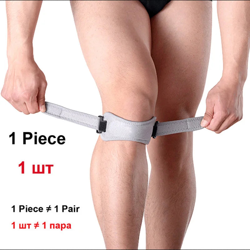 A person's knee is shown wearing a gray adjustable patella tendon support brace.