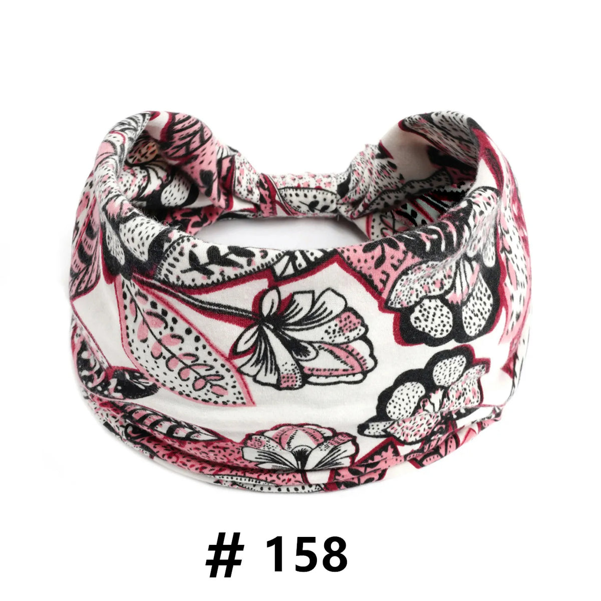 Un bandeau en coton stretch floral rose et noir style bohème, noué en nœud.