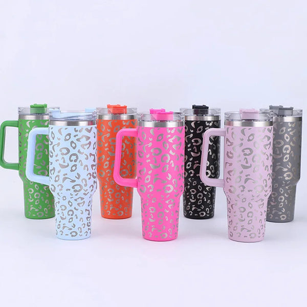 A row of eight large capacity stainless steel insulated cups with straws in various colors and leopard print patterns.
