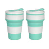 A pair of reusable silicone collapsible coffee cups with lids in white and teal colors.
