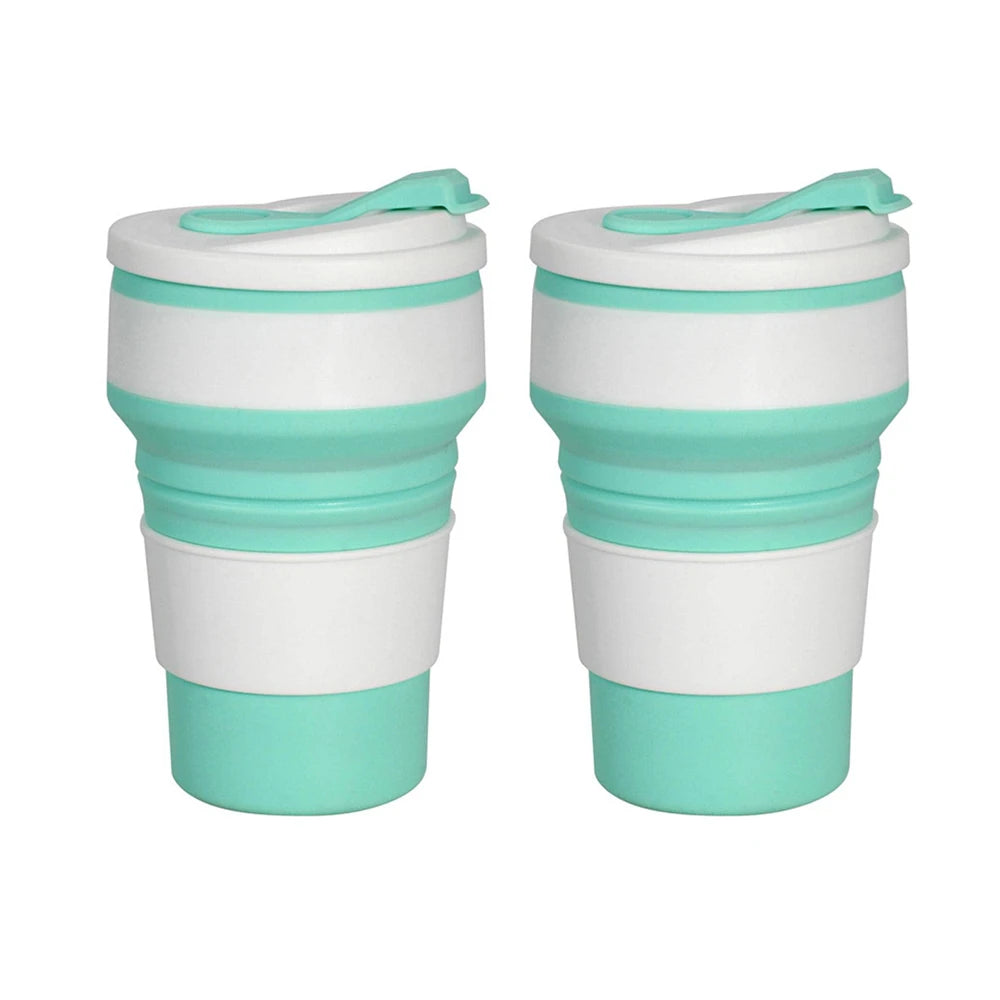 A pair of reusable silicone collapsible coffee cups with lids in white and teal colors.