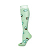 A pair of light green compression socks with a pattern of fruit illustrations.