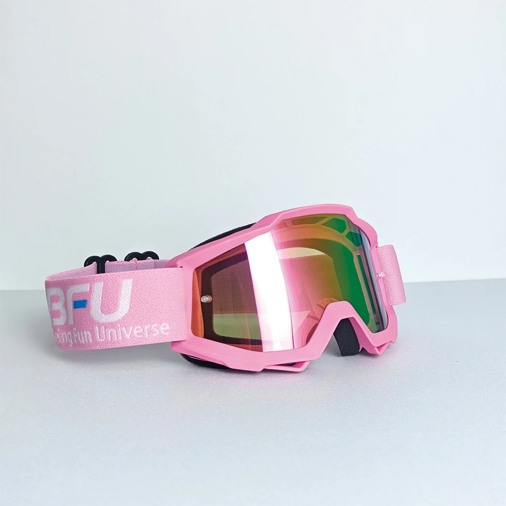 Pink sport-grade skiing goggles with a pink strap and mirrored lenses resting on a white surface.