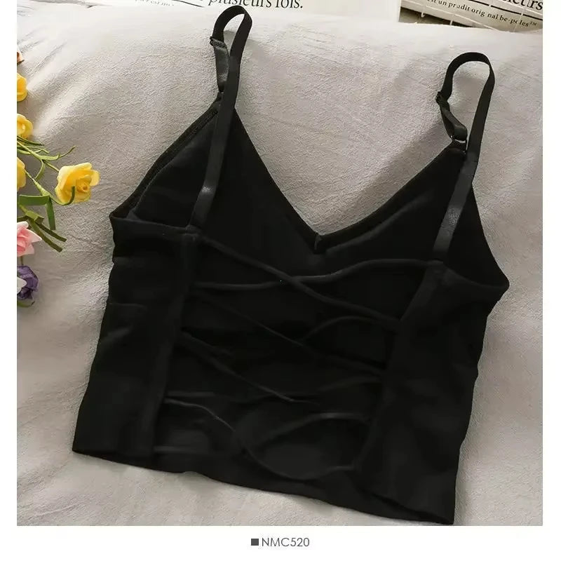 Black off-shoulder camisole tank top for women displayed on a light surface.