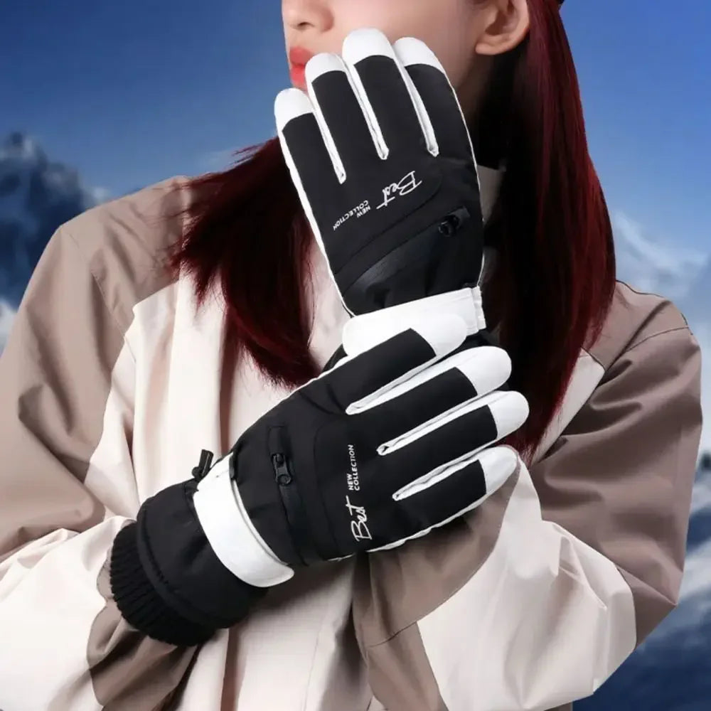 A close-up of a person wearing black and white thermal winter ski and riding gloves with zippered pockets.