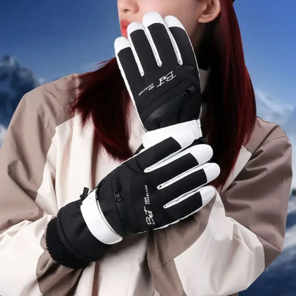 A close-up of a person wearing black and white thermal winter ski and riding gloves with zippered pockets.
