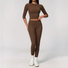 A woman wearing a matching brown long-sleeved top and leggings set for yoga and fitness.