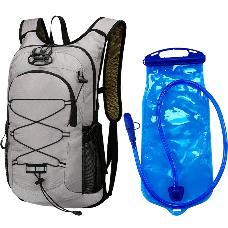 A gray backpack with a blue water bladder and hose attached, used for outdoor activities.