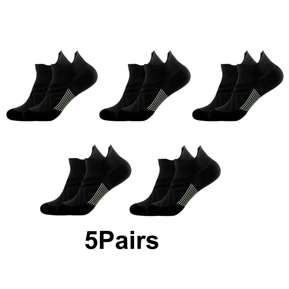 Five pairs of black performance compression sports socks laid out for display.