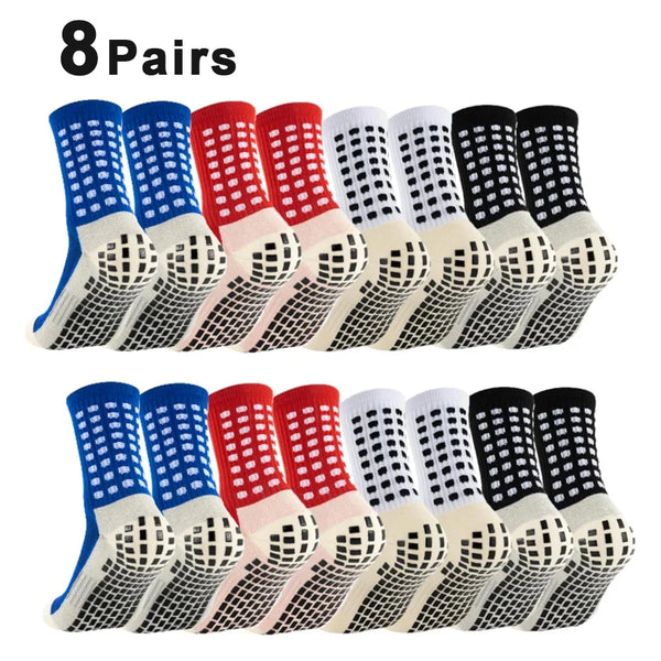 Eight pairs of black and white non-slip silicone football socks displayed in a row.