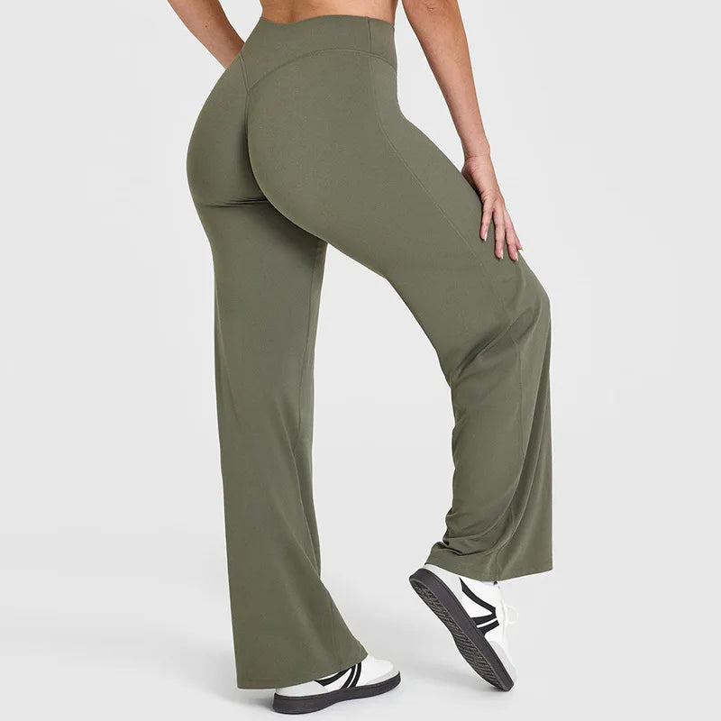 A person is modeling olive green high-waist yoga pants with white sneakers.