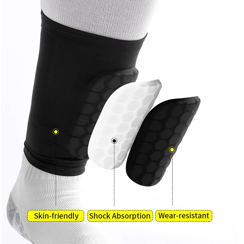 Black honeycomb shin guards worn on a leg, highlighting skin-friendly shock absorption and wear-resistant features.