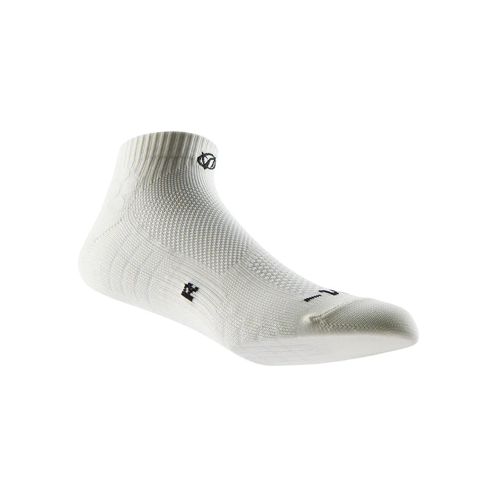 A white performance ankle sock is shown from the side, highlighting its textured knit and fit.