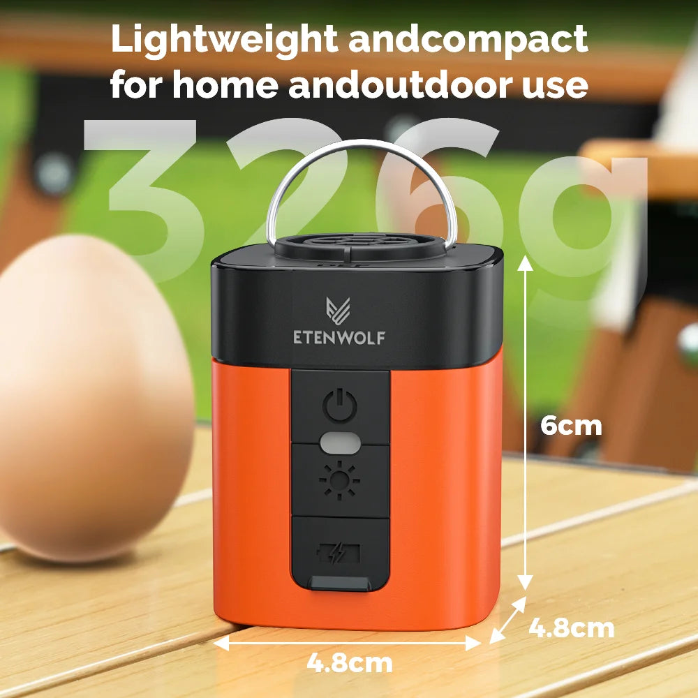 Orange and black portable electric air pump device shown on a wooden surface.