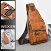 A brown leather crossbody bag with a zipper and strap is shown alongside a smartphone and a hoodie.
