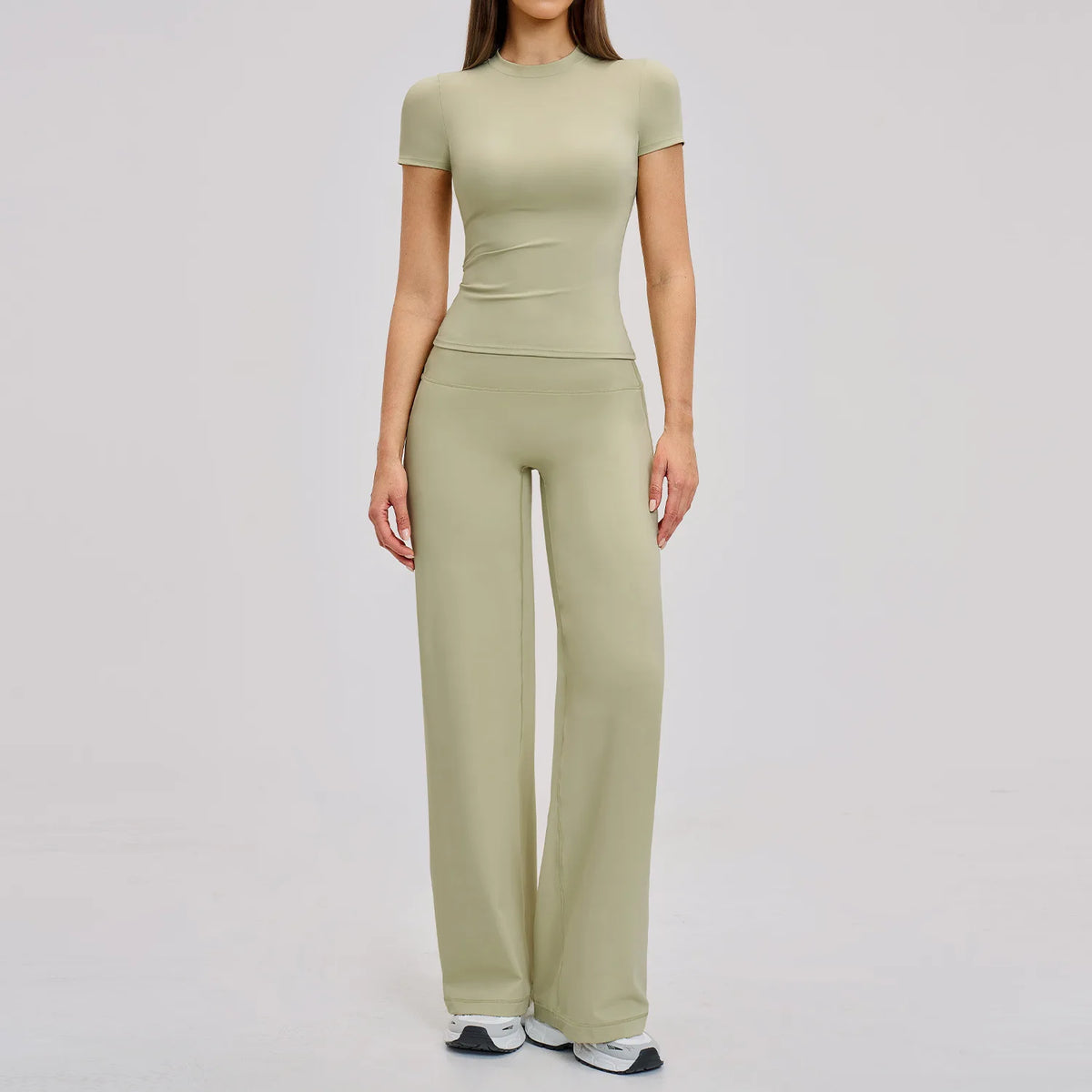 A woman wearing a matching olive green high-waist yoga and gym leggings set.