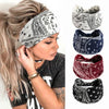 A woman models several bohemian cotton stretch headbands in black, white, and maroon patterns.