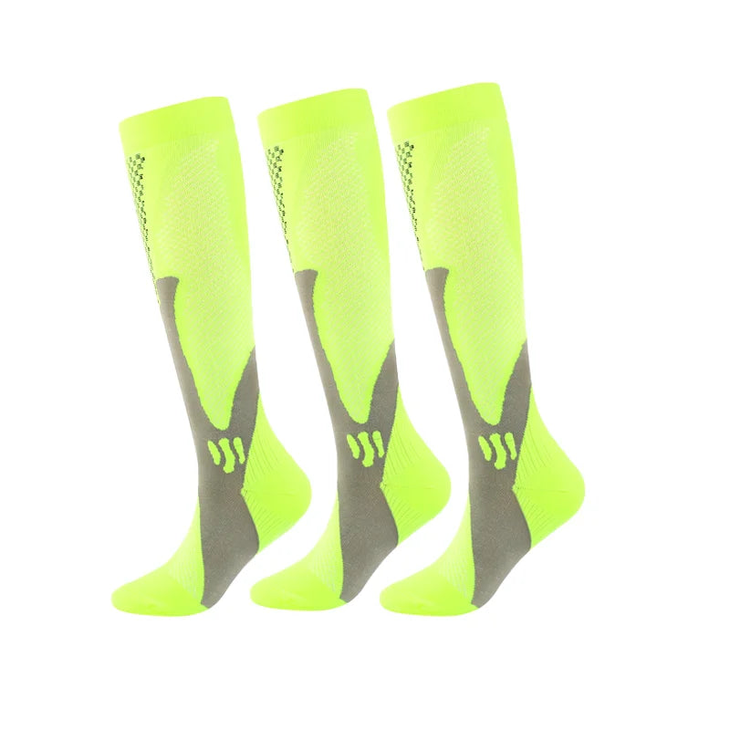 A pair of neon yellow compression socks for men, featuring a mesh design and gray accents.