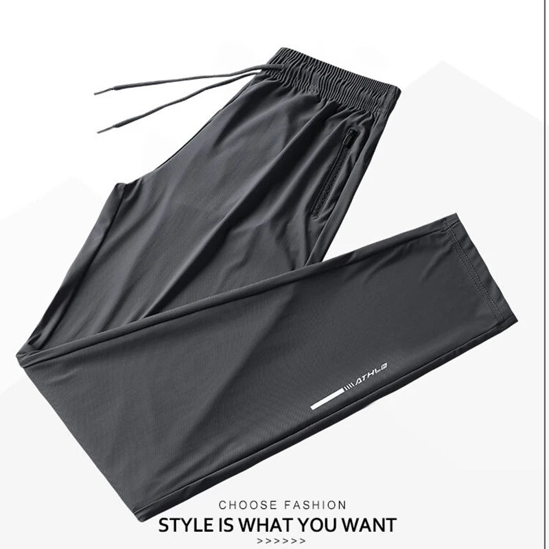 A pair of black men's ice silk performance pants laid flat.