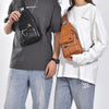 A man wearing a dark t-shirt holds a black leather crossbody bag.