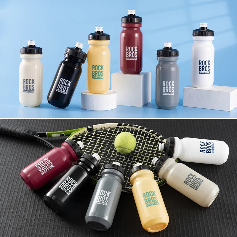 A collection of durable sports water bottles in various colors including red, yellow, black, and white, displayed on a surfac