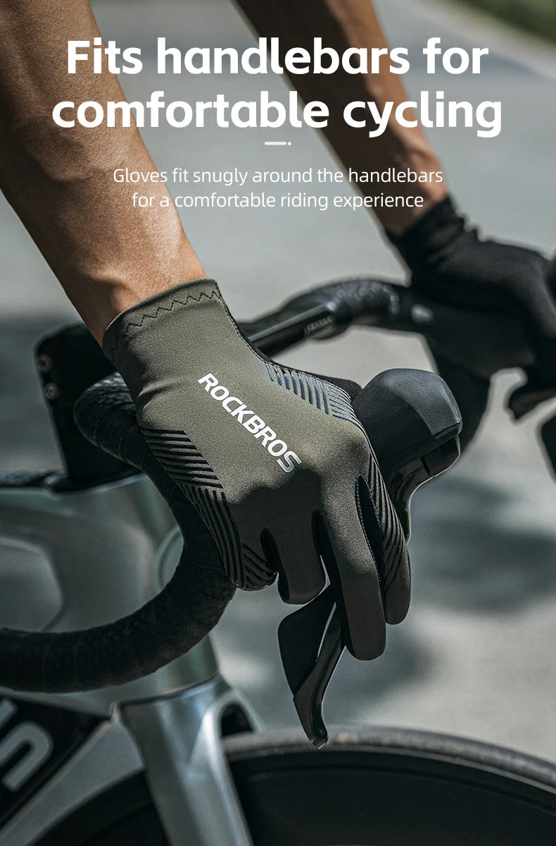 A hand wearing a black cycling glove with the Rockbros logo fits snugly around a bicycle handlebar.
