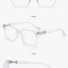 A set of clear, transparent eyeglasses shown in various styles and angles.