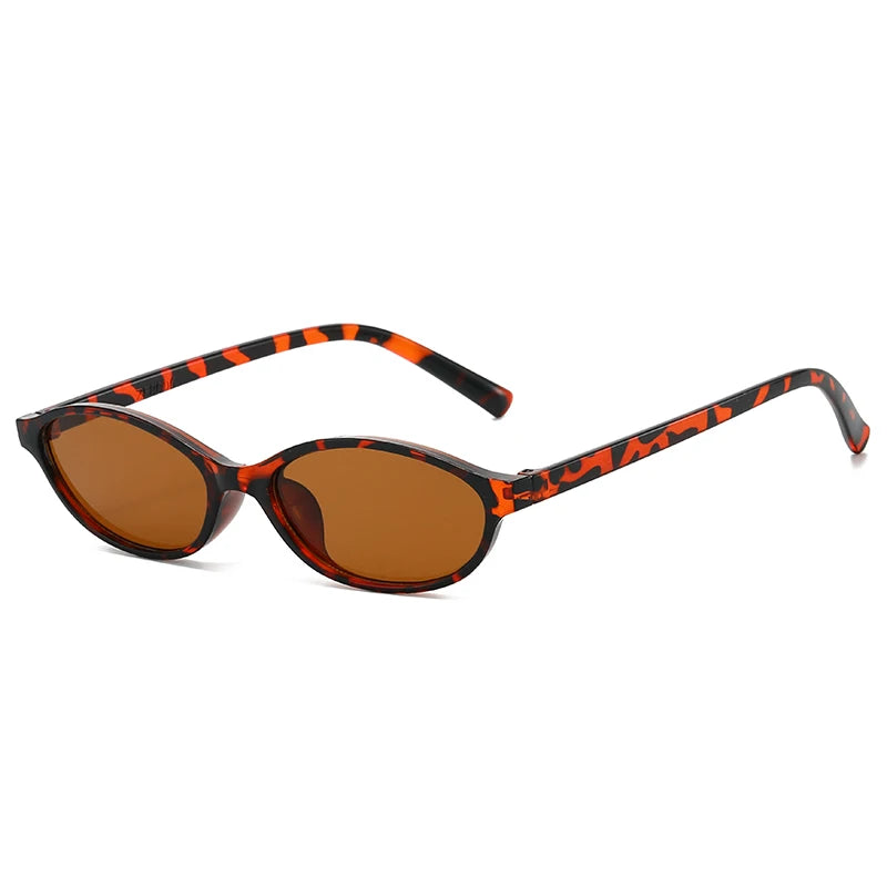 Retro oval frame sunglasses with an orange and black leopard print frame and amber lenses