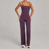 A woman wearing a purple high-waist yoga and fitness tracksuit set.