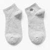 A pair of light gray cotton socks with a small black animal embroidery on the toe.