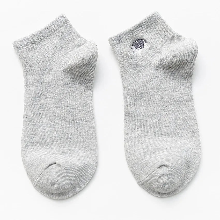 A pair of light gray cotton socks with a small black animal embroidery on the toe.