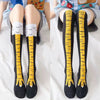 Paire de chaussettes fantaisie en forme de pattes de poulet en coton noires et jaunes, montantes
