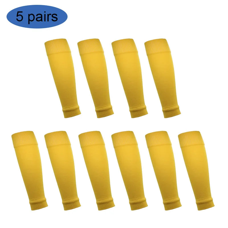 Five pairs of yellow football shin guards for leg protection