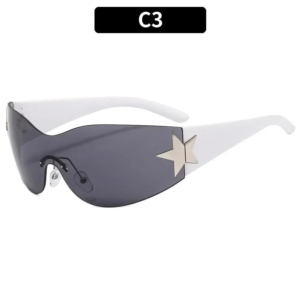 A pair of dark gray gradient sunglasses with a gold star accent, shown against a white background.