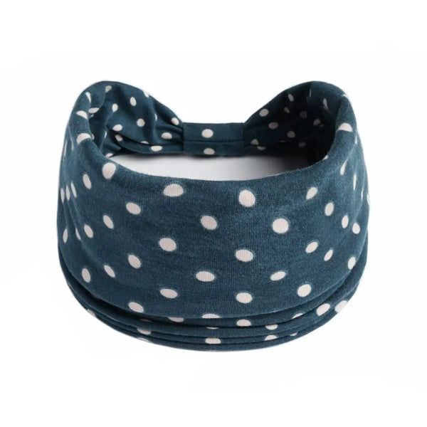 Dunkelblaue Stretch-Baumwoll-Haarband mit weißen Polka Dots, flach dargestellt.
