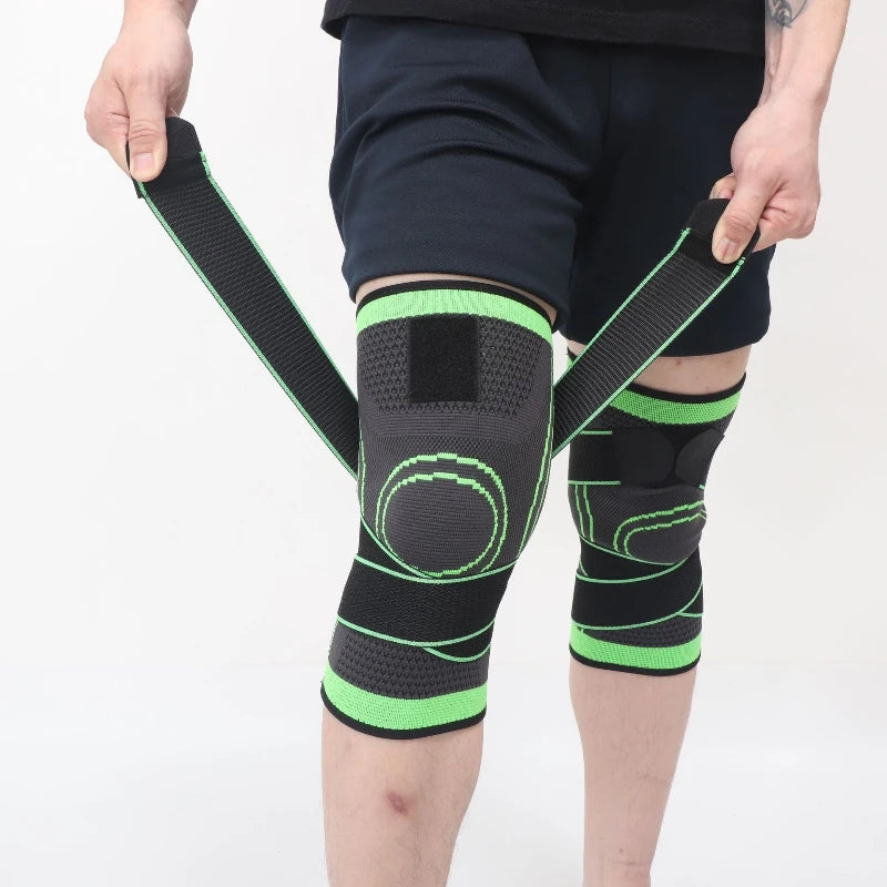 A person is holding adjustable sports knee pads, featuring black and neon green straps and padding, on their leg.